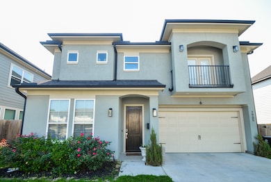 The light-toned exterior is accented by elegant tr