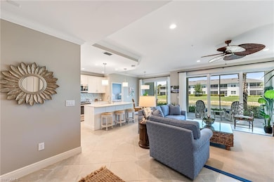 Living room featuring ceiling fan, ornamental mold
