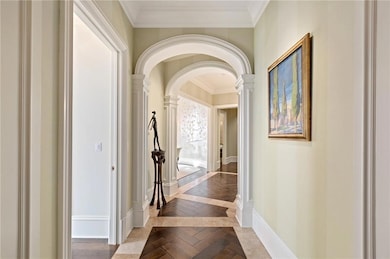 Hallway with parquet flooring and ornamental moldi