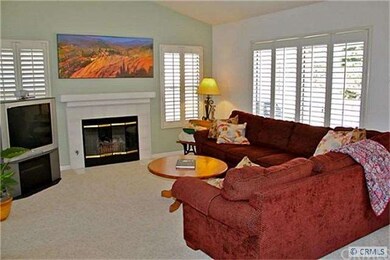 Living Room has Plantation  Shutters & Cozy Firepl