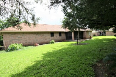 Back of the Home with a Screen in Patio
