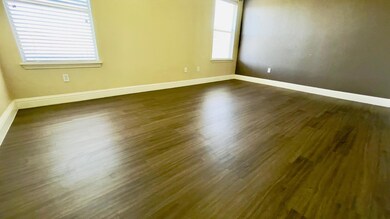 Unfurnished room with baseboards and dark wood-ty