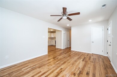 Living room with view of entry to kitchen, hallway