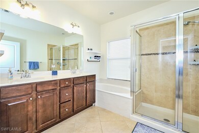 Bathroom with a bath, a sink, tile patterned floor