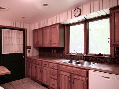 Oak cabinets in kitchen with tiled floor