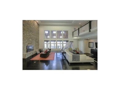 Gleaming hardwoods and stacked stone fireplace
