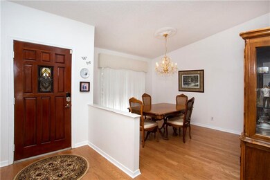 Pretty foyer and dining room with wood flooring.
