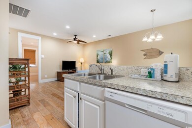 Kitchen with dishwasher, sink, decorative light fi