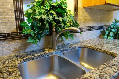 granite counters and tile backsplash