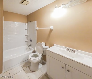 Full bathroom with tile patterned floors, a textur