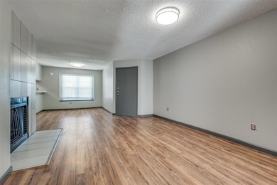 Living room featuring a modern tile surround firep