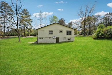 Back of property featuring a lawn