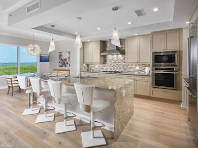 Kitchen with a center island with sink, light wood