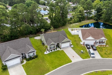 Aerial view of property and surrounding area with a large body of water