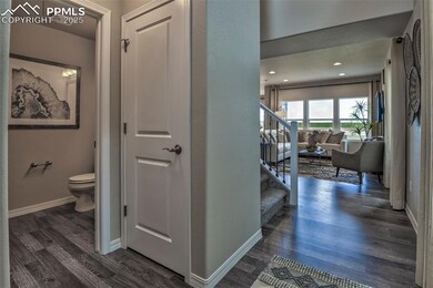 Hallway with dark wood-type flooring and stairway