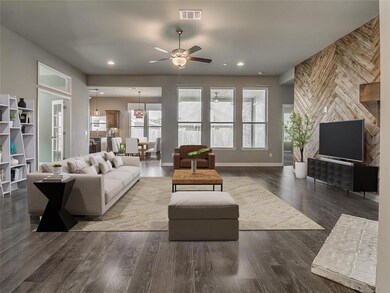 Living room with ceiling fan and dark wood-type fl