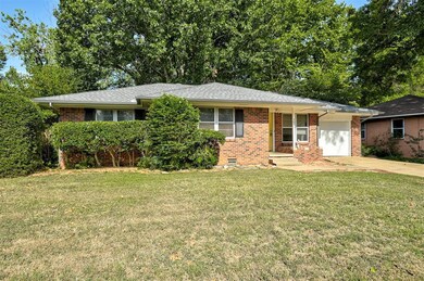Single story home featuring a garage and a front l