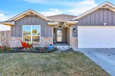 Ranch-style home featuring board and batten siding, a garage, roof with shingles, stone siding, and driveway