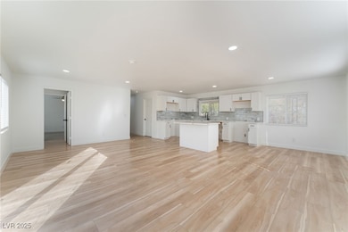 Unfurnished living room featuring light wood-type flooring and recessed lighting