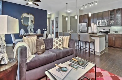 Living room featuring ceiling fan, dark hardwood /