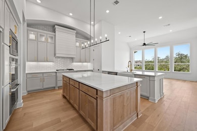 Kitchen featuring a kitchen island, custom exhaus