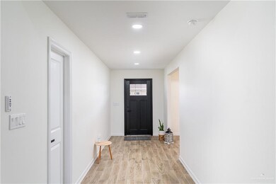 Doorway to outside with light wood-style floors and recessed lighting