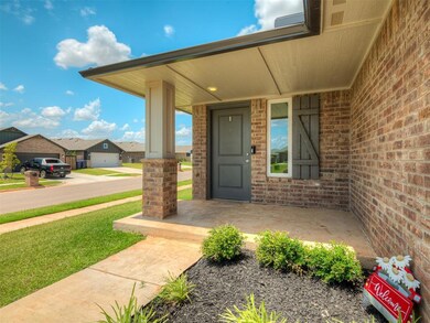 Entrance to property featuring brick siding, covered porch, a residential view, and a yard