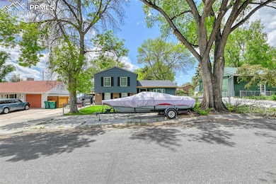 View of front of home with a garage and driveway