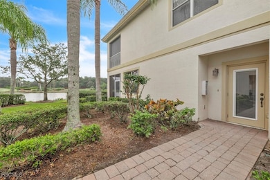Doorway to property with a water view and stucco siding