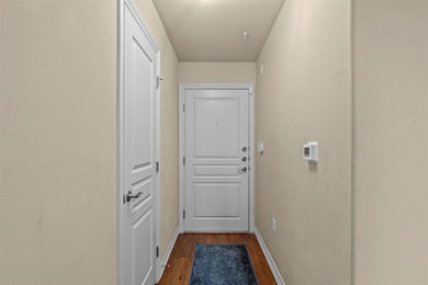 Doorway to outside featuring dark wood-type floori