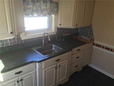 Kitchen with newer cabinets, countertops and tile 
