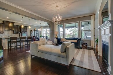 The Great Room opens to a spectacular Kitchen and overlooks the Outdoor Fireplace. 