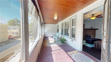 Sunroom / solarium featuring wooden ceiling, a fireplace, and ceiling fan