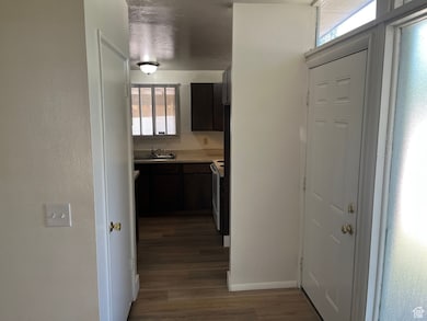 Corridor with plenty of natural light and dark wood finished floors