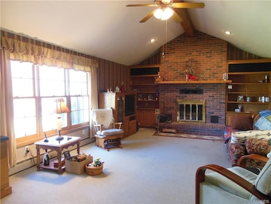 Living room with cathedral ceiling, built in bookc