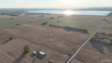 Aerial overview of property's location with a nearby body of water and rural landscape