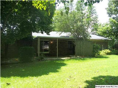 Rear  view  with covered porch  and extensive land