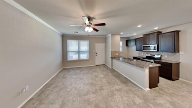Kitchen with decorative backsplash, appliances with stainless steel finishes, kitchen peninsula, and light tile patterned floors