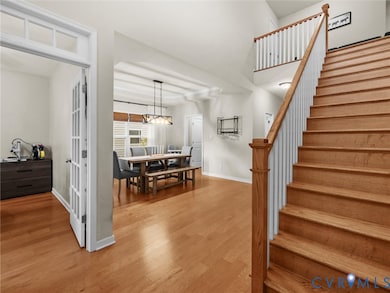 Staircase featuring wood finished floors and baseboards