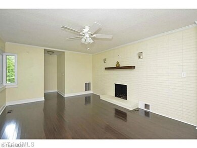 Living Room. Gorgeous wood floors.  Brick hearth, wired for a flat screen.  Wood burning fireplace.