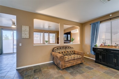 Living area with stone tile floors, a wall mounted