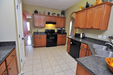 The kitchen comes equipped with a range/oven, dish