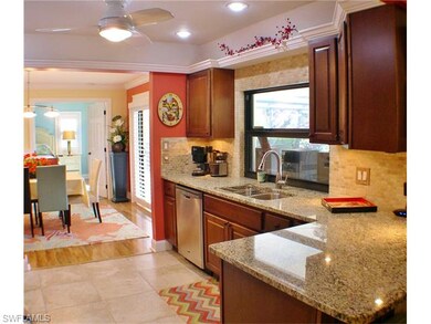 Updated kitchen with granite counters and stainless appliances.  Crown molding, wood cabinets and breakfast bar.  Looking out to dining area and on to master bedroom.  Kitchen window looks out to lanai, pool and golf course!