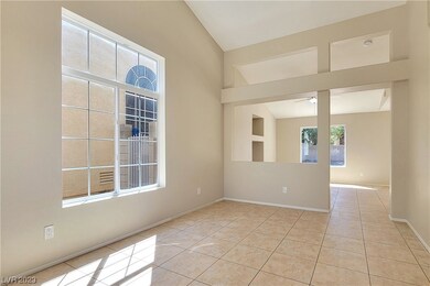 Living Room with Vaulted Ceiling and Tile Flooring