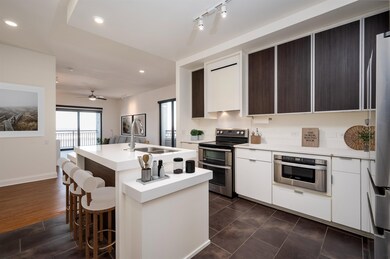 Kitchen with ceiling fan, a center island with sin