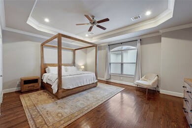 The elegant Primary Suite boasts a tray ceiling ma