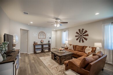 Inviting tall ceilings, pretty windows and recess cans beautifully brighten this family room.