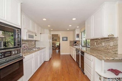 Large galley kitchen with solid granite counters a