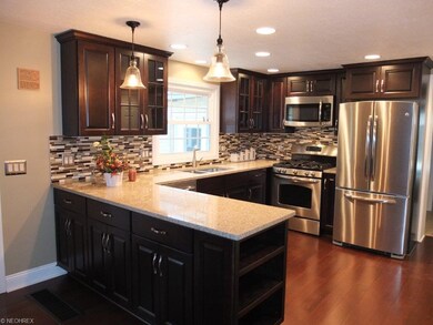 Beautiful open kitchen with maple cabinets and sta