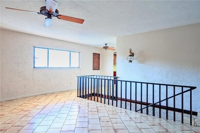 Unfurnished room featuring baseboards, a textured 